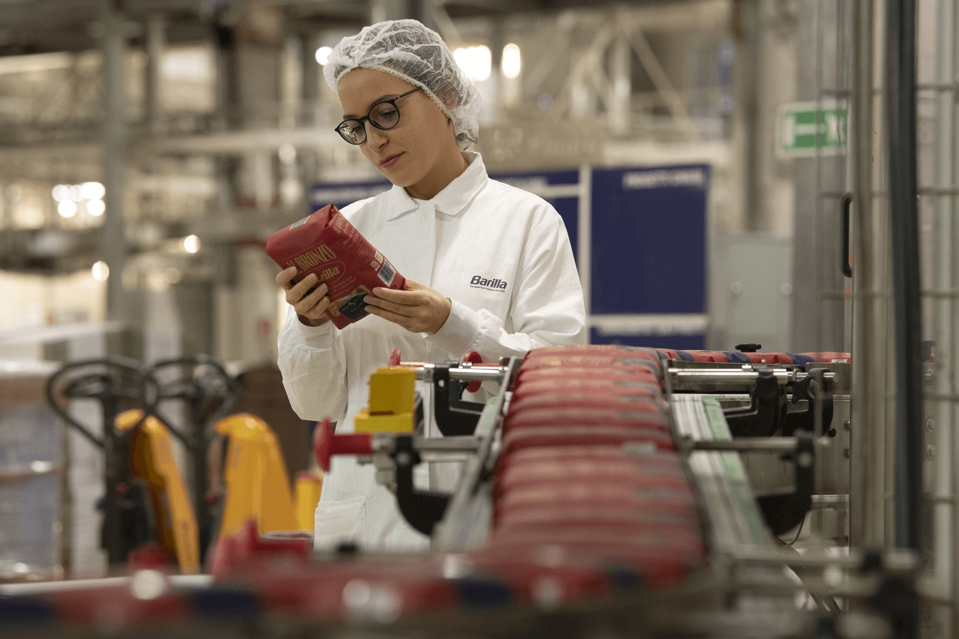 Barilla Factory Worker Holding Package of Barilla® Al Bronzo® Pasta